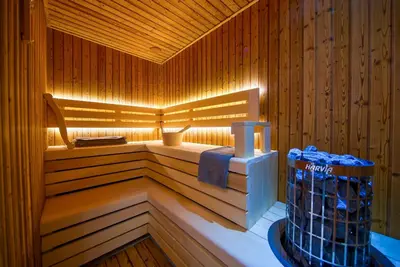 a sauna with a tub with towels in it at Villa Solaria in Sveti Stefan