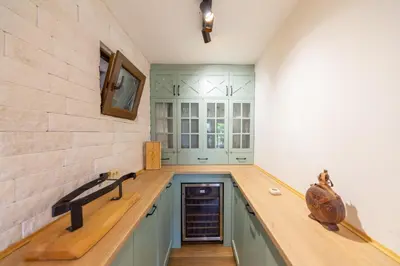 a kitchen with green cabinets and a counter top at Sunset & Sunrise Villas in Stanisici-Two Villas With Common Pool in Budva