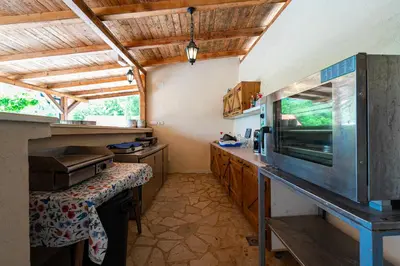 a kitchen with a counter and a sink in it at Sunset & Sunrise Villas in Stanisici-Two Villas With Common Pool in Budva