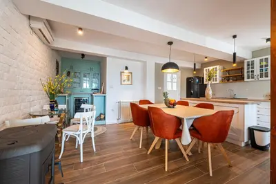 a kitchen and dining room with a table and chairs at Sunset & Sunrise Villas in Stanisici-Two Villas With Common Pool in Budva