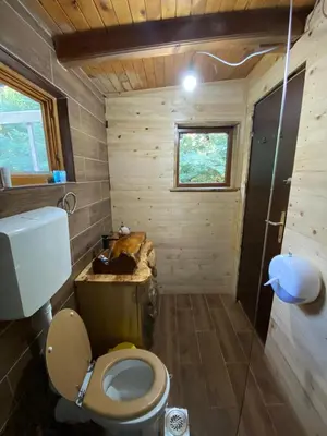 a small bathroom with a toilet and a sink at Sojenica Pustolov - Ada Bojana in Ulcinj