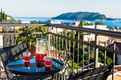 a table with two glasses on top of a balcony at Boutique Hotel Tate By Aycon in Budva