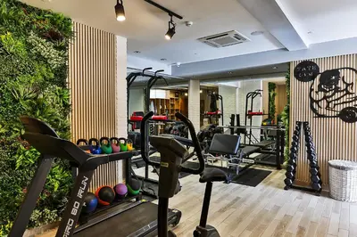 a gym with cardio equipment in a hotel room at Boutique Hotel Tate By Aycon in Budva