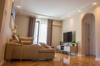a living room with a couch and a tv at Ana's Place in Kotor
