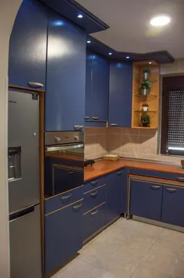 a kitchen with blue cabinets and a refrigerator at Ana's Place in Kotor