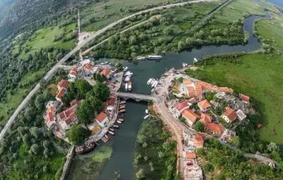 an aerial view of a village on a river at JOCKER in Virpazar