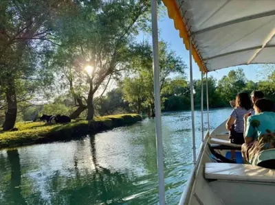 a group of people riding on a boat on a river at JOCKER in Virpazar