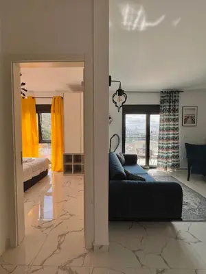 a living room with a couch and a bedroom at Apartment Tulip of Becici in Budva