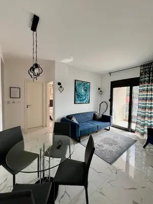 a living room with a blue couch and chairs at Apartment Tulip of Becici in Budva