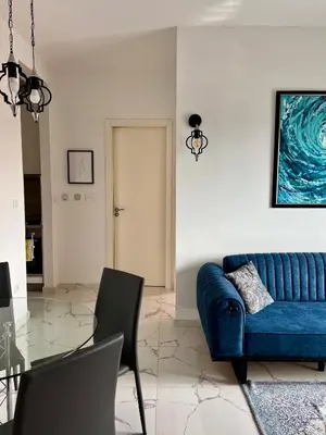 a living room with a blue couch and a table at Apartment Tulip of Becici in Budva