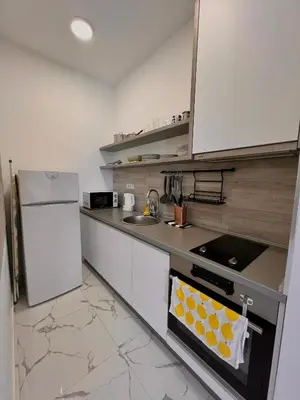 a kitchen with a white refrigerator and a stove top oven at Apartment Tulip of Becici in Budva