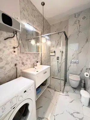 a bathroom with a washing machine and a sink at Apartment Tulip of Becici in Budva