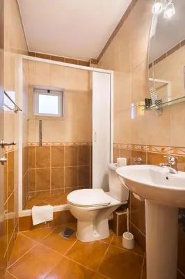 a bathroom with a toilet and a sink and a shower at Villa Ljubanovic in Budva