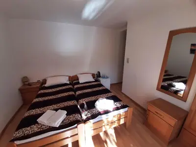 a bedroom with a bed and a large mirror at Apartments Stanivukovic in Budva