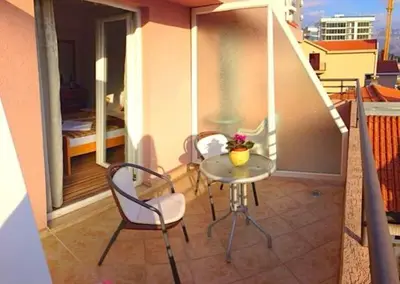 a balcony with a table and chairs on a balcony at Apartments Stanivukovic in Budva