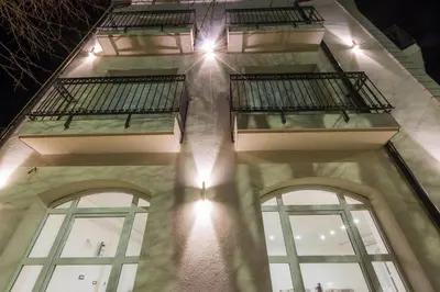 a building with three windows and lights on it at Hotel Dapčević in Cetinje