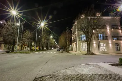 an empty street at night with street lights at Hotel Dapčević in Cetinje