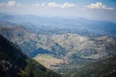 an aerial view of a mountain valley with a town at Hotel Dapčević in Cetinje