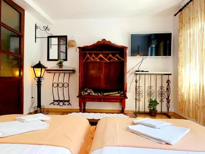two beds in a room with a bed istg at Villa Urbana, Old Town Budva in Budva