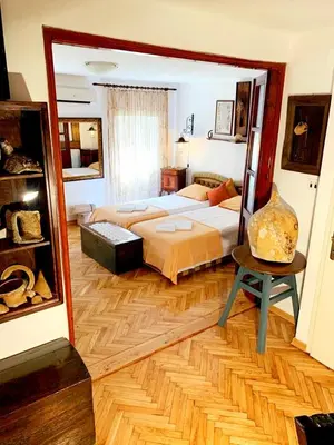 a large bedroom with a bed and a mirror at Villa Urbana, Old Town Budva in Budva