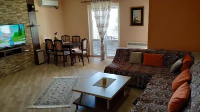 a living room with a couch and a table at Apartments Abramovic 2 in Sutomore