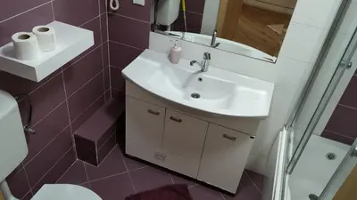 a bathroom with a sink and a toilet and a mirror at Apartments Abramovic 2 in Sutomore