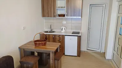 a small kitchen with a table and a sink at Apartments Abramovic 2 in Sutomore