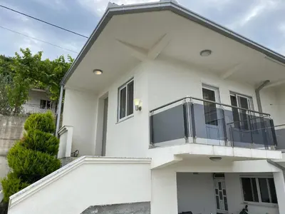a white house with a balcony at ANDI Apartment in Ulcinj