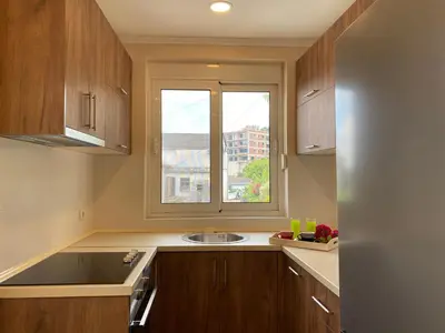 a kitchen with a sink and a window at ANDI Apartment in Ulcinj