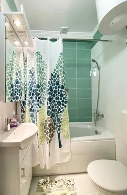 a bathroom with a shower curtain and a toilet and a tub at ANDI Apartment in Ulcinj
