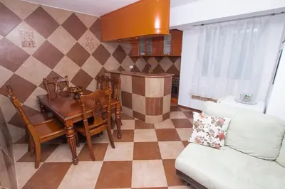 a living room with a table and a couch at Lea Apartment in Bar