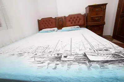 a bed with a drawing of boats on it at Lea Apartment in Bar