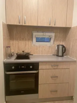 a kitchen with a stove and a microwave at Anna Apartment in Utjeha