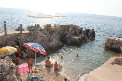 a group of people in the water at a beach at Anna Apartment in Utjeha
