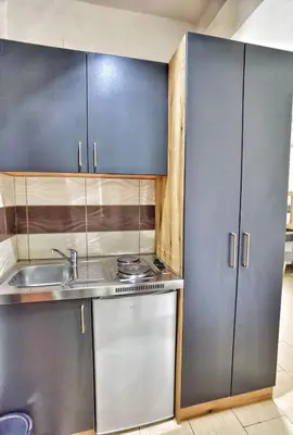 a kitchen with stainless steel cabinets and a sink at MD APARTMENTS in Ulcinj