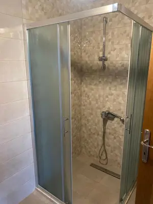 a shower with a glass door in a bathroom at Apartman 02 in Bar