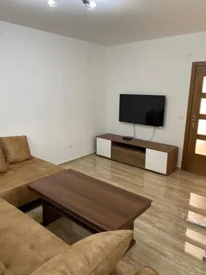 a living room with a television and a table at Apartman 02 in Bar