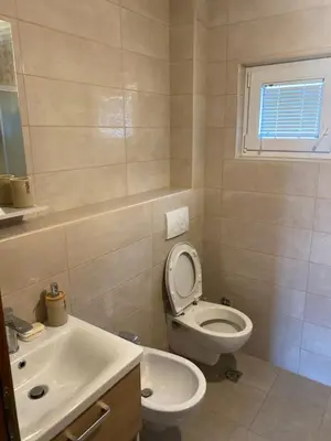 a bathroom with a toilet and a sink at Apartman 02 in Bar