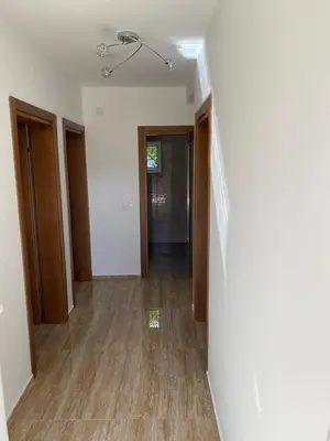 an empty hallway with wood floors and a ceiling at Apartman 02 in Bar