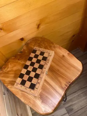 a chess board sitting on top of a wooden table at Cottage Four Olives in Ulcinj