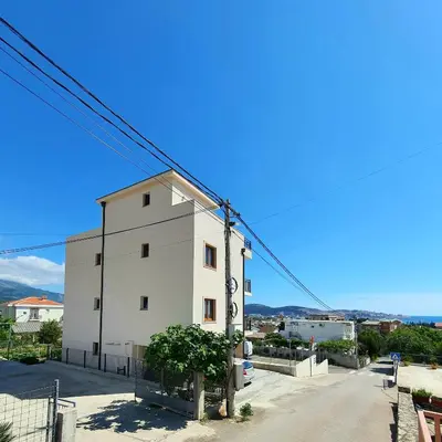 a white building on the side of a street at Family Apartments in Bar