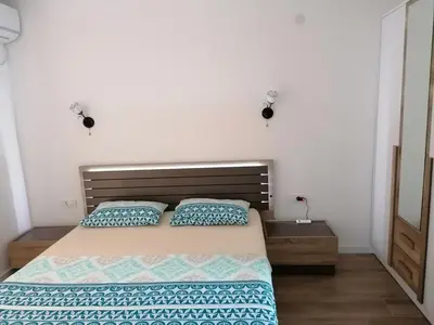 a bedroom with a bed with two pillows on it at Riki Dream in Dobra Voda