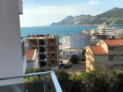 a view from a balcony of a city and the ocean at Riki Dream in Dobra Voda
