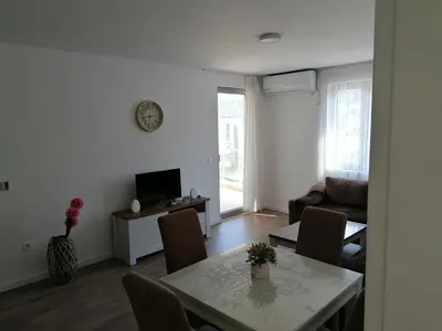 a living room with a table and a couch at Riki Dream in Dobra Voda