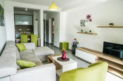 a living room with a couch and a tv at BUZUKU Apartments Liman (Mediterraneo) in Ulcinj