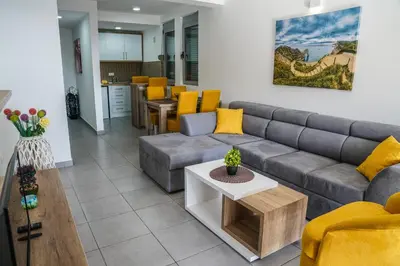 a living room with a couch and a table at BUZUKU Apartments Liman (Mediterraneo) in Ulcinj