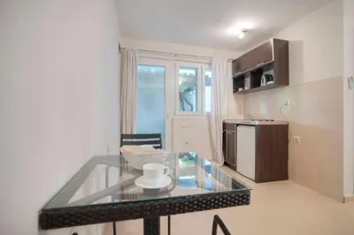 a kitchen with a glass table in a room at Mandir apartments - Center in Budva