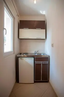a small kitchen with a sink and a dishwasher at Mandir apartments - Center in Budva