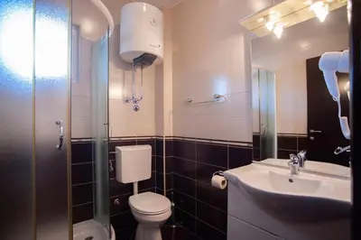 a small bathroom with a toilet and a sink at Mandir apartments - Center in Budva