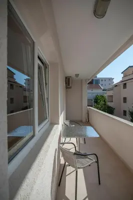 two chairs and a table on a balcony at Mandir apartments - Center in Budva